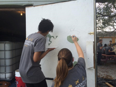 students painting a wall