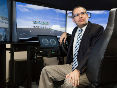 Muhammed Abdel-Aty sits behind wheel of simulator