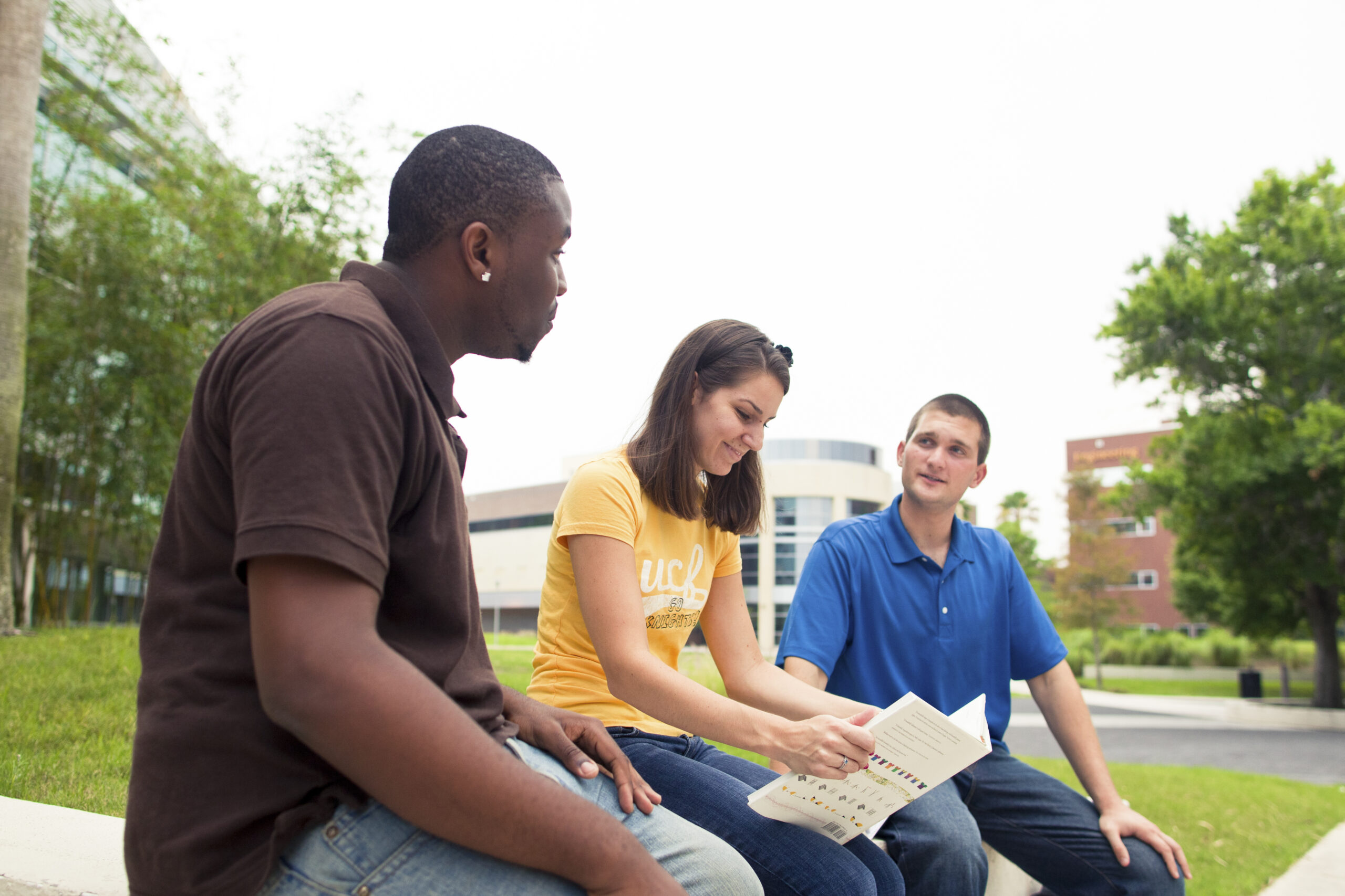 Three students sitting outside and talking