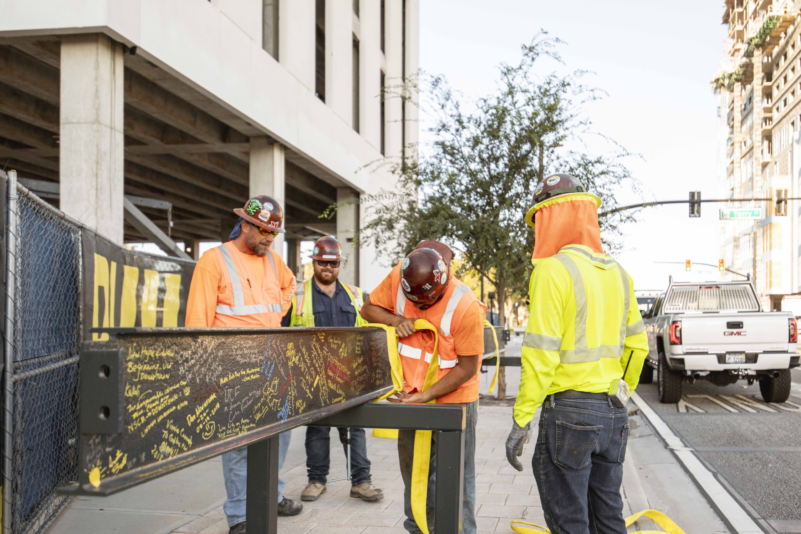 Construction workers lifting a beam