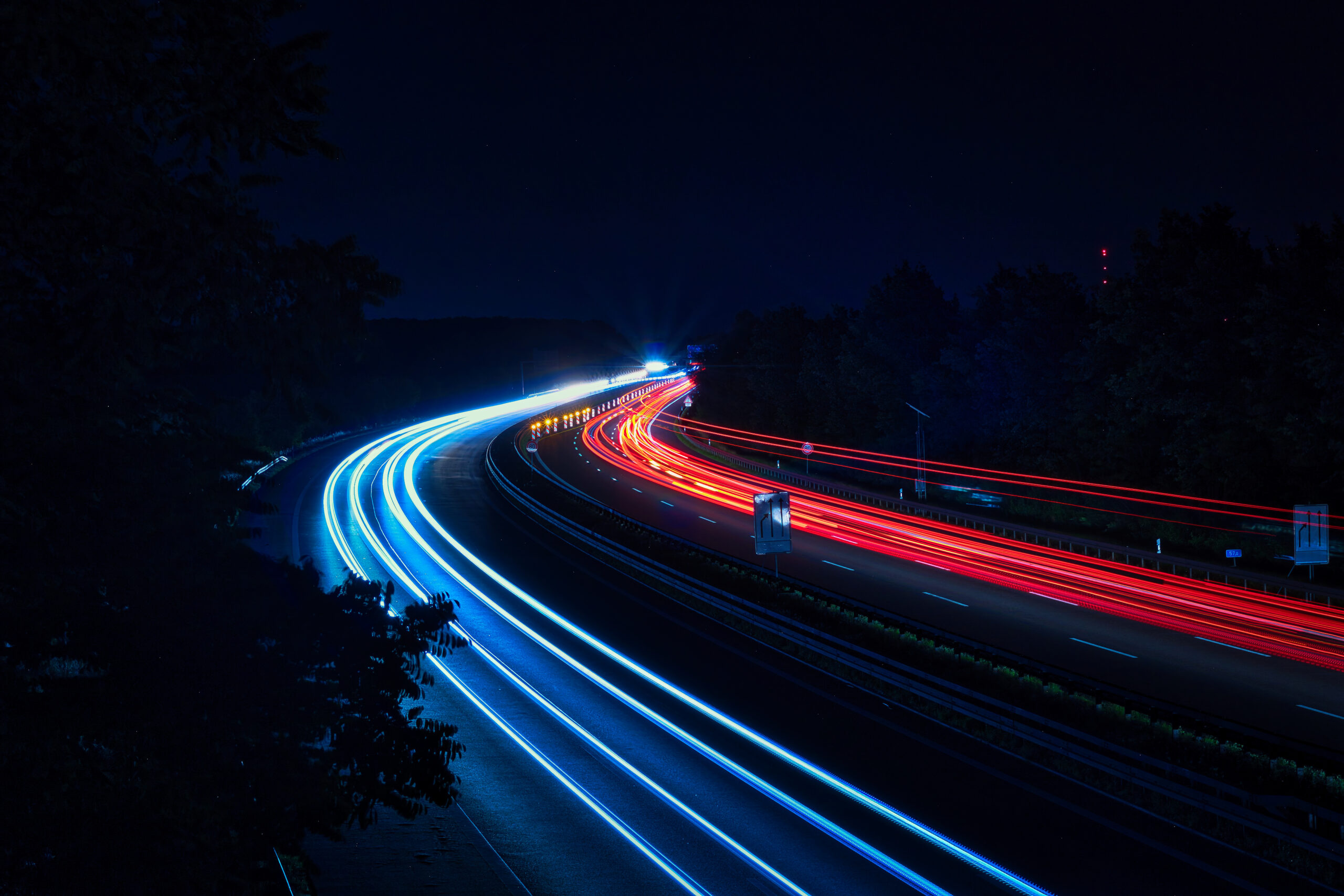 Highway lit up blue and red at night